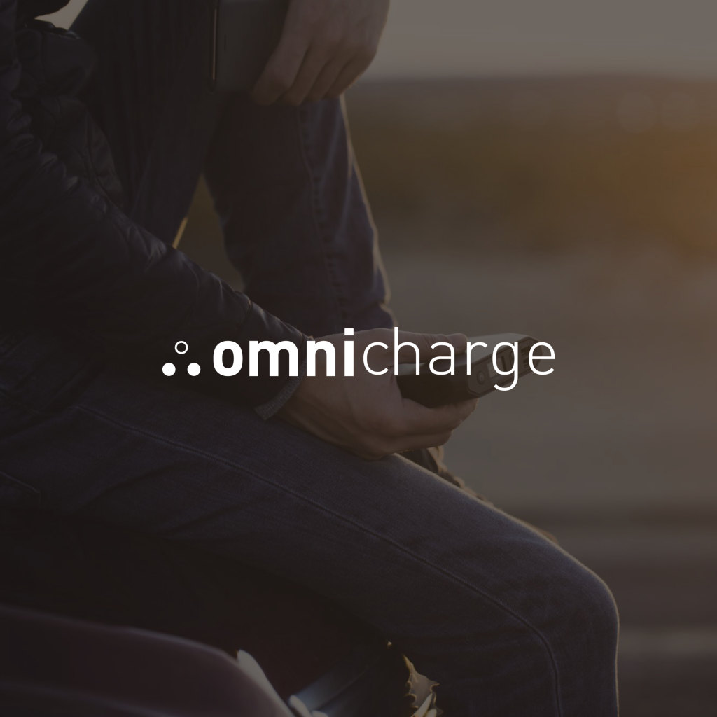 Omnicharge logo over a photo of the Omni 20 in hand at sunset